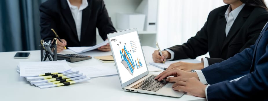 Business intelligence analyst team use BI software on laptop to analyze financial data dashboard. Business technology empower corporate executive to make strategic decision in panorama. Shrewd