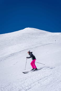 Woman skiing with pink trousers