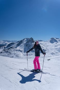Woman skiing with pink trousers in Formigal, Spain
