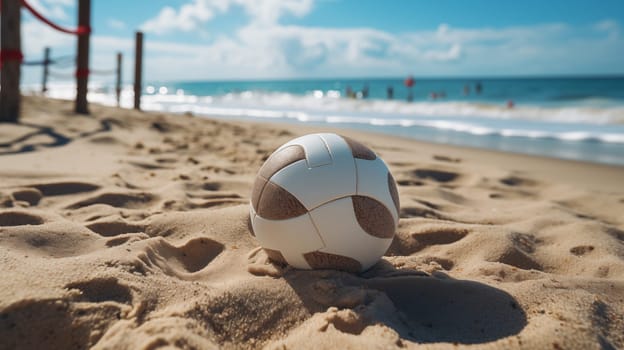 A volleyball lies on a sandy beach with waves and beachgoers in the blurred background, under a sunny sky.