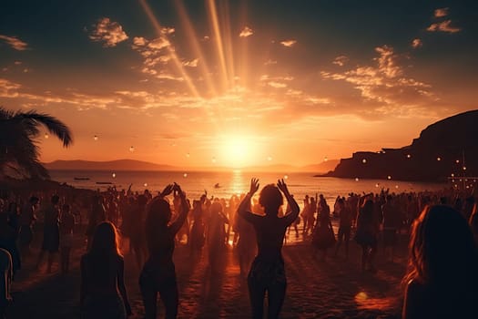 A crowd of people dancing and having fun at a beach party at sunset. Vacation concept.