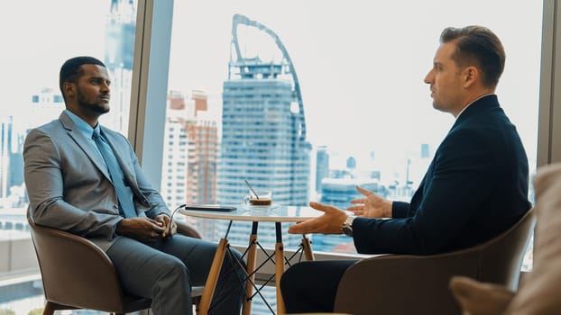 Ornament office with cityscape view, business college or MBA student discussing their future career path at coffee break. Corporate consultant guiding business insight and idea for client.