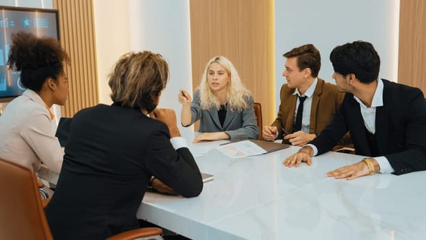 Diverse office worker employee working and brainstorm on strategic business marketing planning. Teamwork and positive attitude create productive and supportive in ornamented business office workplace.