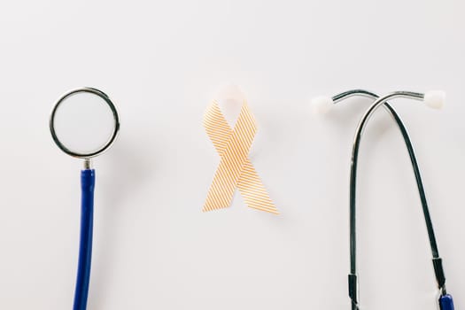 Pink awareness ribbon sign and stethoscope of International World Cancer Day campaign month isolated on white background with copy space, concept of medical and health care support, 4 February