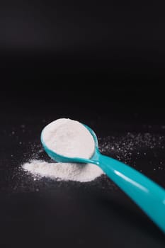 Close up of baby milk powder and spoon on tile background