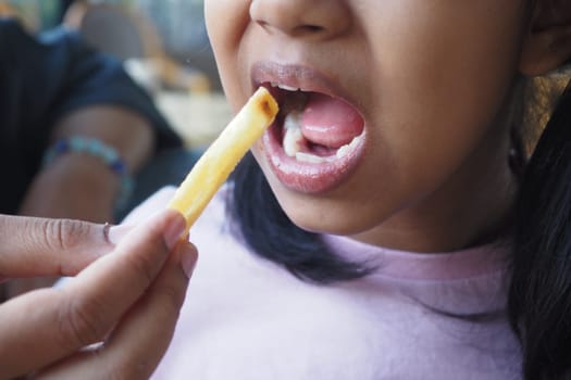 child eating french fries close up ,