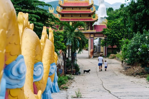 Father and son tourists walking in Vietnam Buddhist Temple, happy childhood, exploring world.