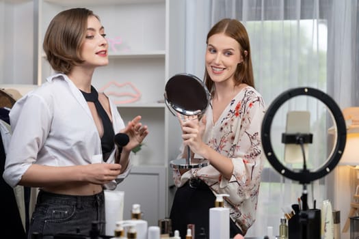 Woman influencer shoot live streaming vlog video review makeup utmost social media or blog. Happy young girl with cosmetics studio lighting for marketing recording session broadcasting online.