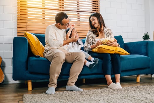 A delightful family indulges in TV and popcorn savoring moments of togetherness on grooved sofa. father mother daughter and sibling create an atmosphere filled with joy bonding and relaxation.