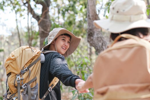 An Asian couple spends their free time on a hiking trip together..