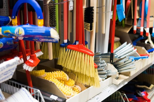 Large assortment of brushes for cleaning premises in store. Trade in floor cleaning equipment