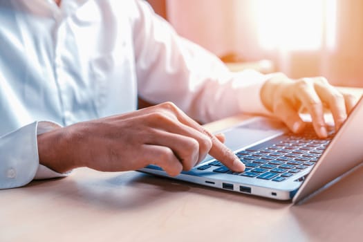 Businessman hand typing on computer keyboard of a laptop computer in office. Business and finance concept. uds