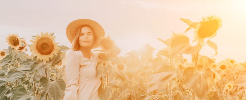 Woman in the sunflowers field. Summer time. Young beautiful woman standing in sunflower field.