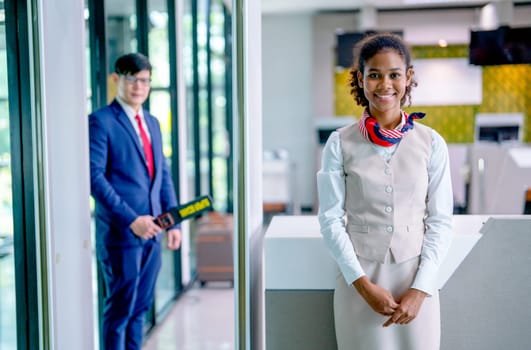 Portrait of air hostess and airline staff at gate of airport to welcome and check the security of passenger before go inside of transportation by airplane.