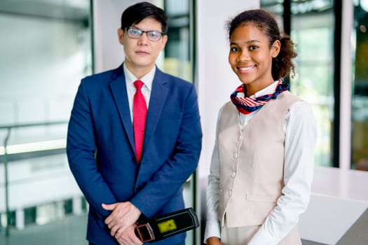 Portrait and close up of air hostess and airline staff at gate of airport to welcome and check the security of passenger before go inside of transportation by airplane.