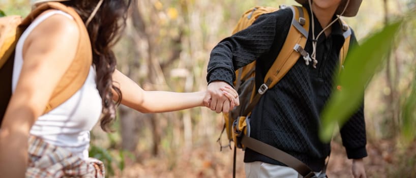 Lovely couple lesbian woman with backpack hiking in nature. Loving LGBT romantic moment in mountains.