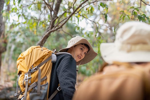 Lovely couple lesbian woman with backpack hiking in nature. Loving LGBT romantic moment in mountains.