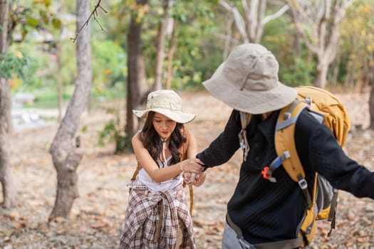 Lovely couple lesbian woman with backpack hiking in nature. Loving LGBT romantic moment in mountains.