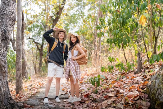 Lovely couple lesbian woman with backpack hiking in nature. Loving LGBT romantic moment in mountains.