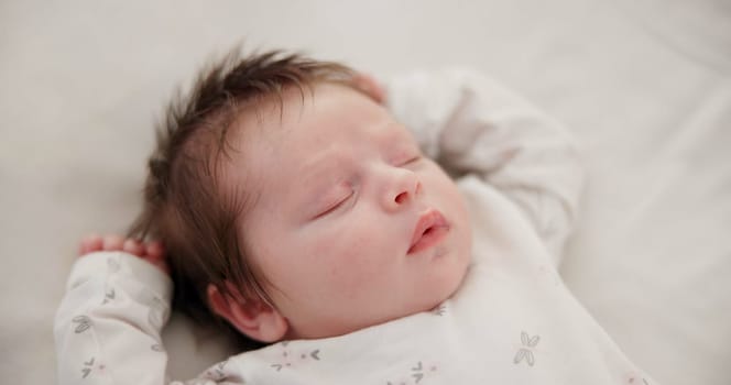 Tired baby, sleeping and nursery bed with morning, nap and dreaming of a young newborn at home. Cozy, sleepy kid and calm with health development from rest and peace in a house with closeup and care.