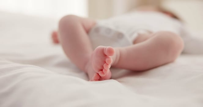 Sleeping, family and feet of baby on bed for child care, dreaming and relax in nursery. Adorable, cute and closeup of toes of innocent newborn infant for health, wellness and development at home.