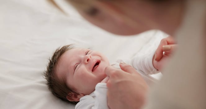 Baby, mother and playing on bed in nursery for bonding, love and support for child development. People, woman and newborn in bedroom of home with fun, hands or happiness for bond, care and smile.