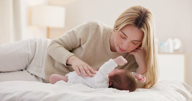 Children, love and a mother on the bed with her baby for sleep, rest or bonding together in a home. Family, bedroom and a woman in an apartment with her newborn infant to relax for care or growth.