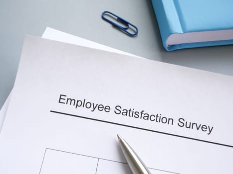 Employee satisfaction survey and pen on the desk.