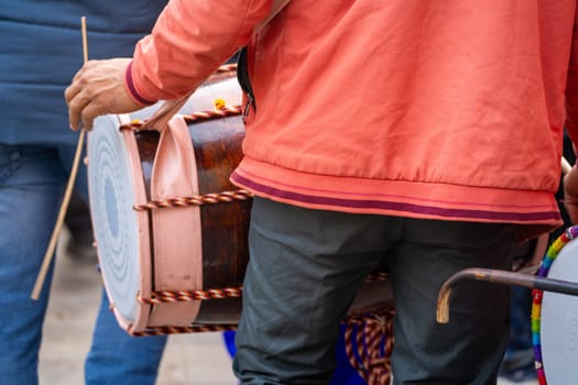 Zoomed in shot showing dhol drummer an indian instrument used in celebration wedding, religious puja prayers and events in India