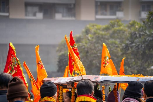 Ayodhya, Uttar Pradesh, India - 22nd Jan 2024: Zoomed in shot showing group of people carrying bhagwa saffron flag celebrating the Pran Pratishtha consecration of Ram mandir temple massive celebration in India