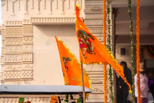 Ayodhya, Uttar Pradesh, India - 22nd Jan 2024: Zoomed shot showing crowd of people carrying flag celebrating the Pran Pratishtha consecration of Ram mandir temple massive celebration in India