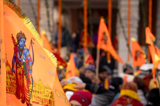 Ayodhya, Uttar Pradesh, India - 22nd Jan 2024:Zoomed shot showing crowd of people carrying flag celebrating the Pran Pratishtha consecration of Ram mandir temple massive celebration in India