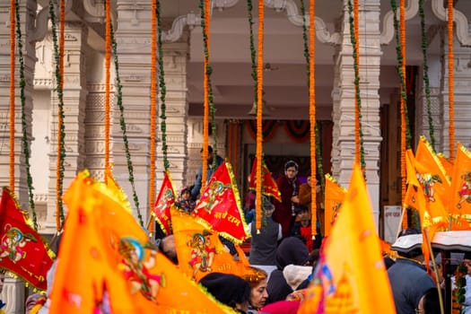 Ayodhya, Uttar Pradesh, India - 22nd Jan 2024:Zoomed shot showing crowd of people carrying flag celebrating the Pran Pratishtha consecration of Ram mandir temple massive celebration in India