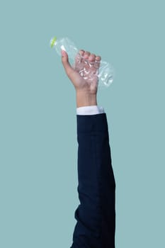 Businessman's hand holding plastic bottle on isolated background. Eco-business recycle waste policy in corporate responsibility. Reuse, reduce and recycle for sustainability environment. Quaint