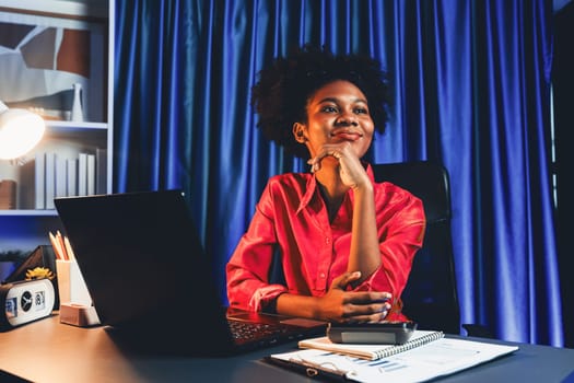 Working African woman with happy glowing, smiling face, getting new job project with good deal or marketing course scholarship information on laptop screen. Concept of cheerful expression. Tastemaker.