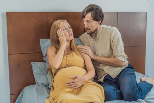 Expectant woman feels unwell, husband comforts and reassures her during a challenging pregnancy.