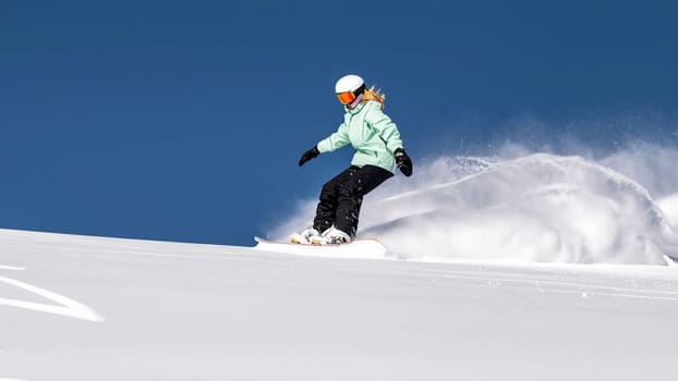 Snowboarder sliding down the hill. High quality photo