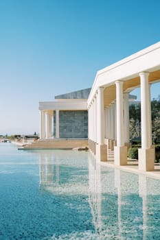 Long pool near terraces with columns. Hotel Amanzoe, Peloponnese, Greece. High quality photo