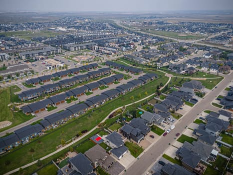 Drone capture of Evergreen, Saskatoon, highlighting its unique layout and lush green spaces.