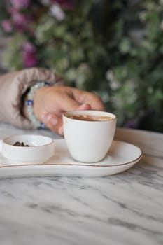 a cup of turkish coffee on table .