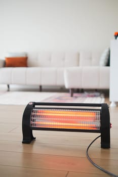 Modern electric infrared heater in living room, closeup. High quality photo