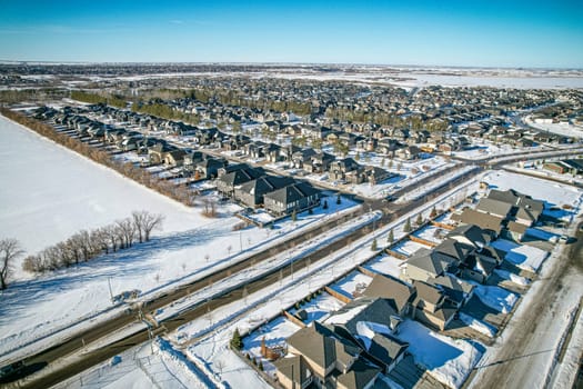 Drone capture of Evergreen, Saskatoon, highlighting its unique layout and lush green spaces.