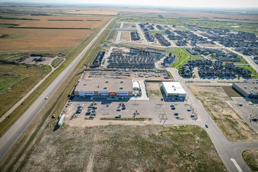 Drone image capturing the town of Warman in Saskatchewan during the summer season, highlighting its suburban and residential areas surrounded by lush greenery and vibrant atmosphere