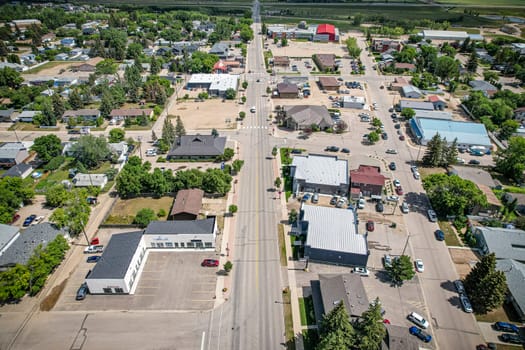 Drone image capturing the town of Warman in Saskatchewan during the summer season, highlighting its suburban and residential areas surrounded by lush greenery and vibrant atmosphere