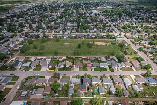 Drone image capturing the town of Martensville in Saskatchewan during the summer season, highlighting its suburban and residential areas surrounded by lush greenery