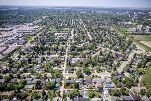 Drone image showcasing the charm of Grosvenor Park, Saskatoon, with its residential areas, greenery, and community spaces.