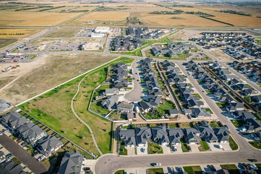 Drone image capturing the town of Warman in Saskatchewan during the summer season, highlighting its suburban and residential areas surrounded by lush greenery and vibrant atmosphere