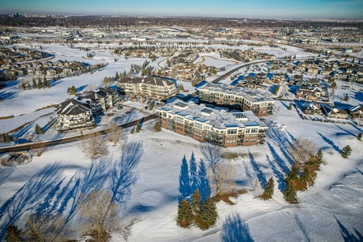 Drone image capturing the serene beauty of Willows neighborhood in Saskatoon during the winter season, with its snow-covered streets and residential charm