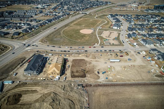 Drone capture of Evergreen, Saskatoon, highlighting its unique layout and lush green spaces.