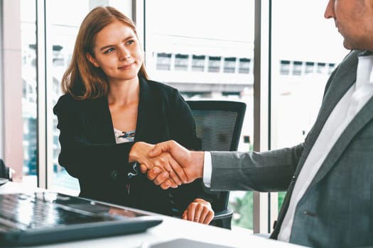 Businessman executive handshake with businesswoman worker in modern workplace office. People corporate business deals concept. uds
